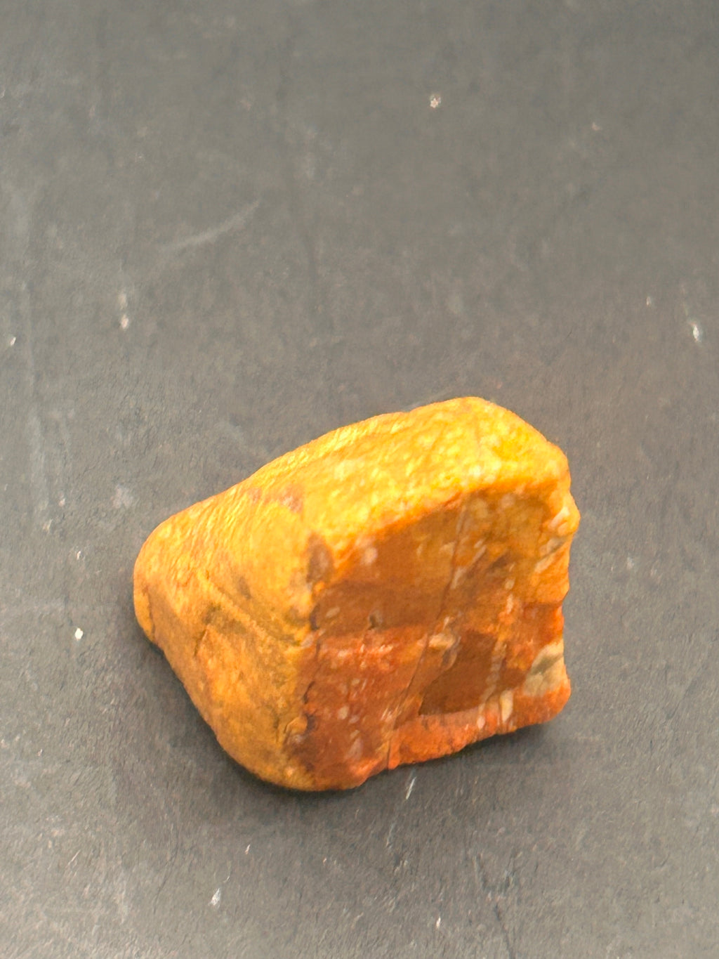 Amberroot Emberstone (1.05 oz) is a vivid fragment of petrified, jasperized wood