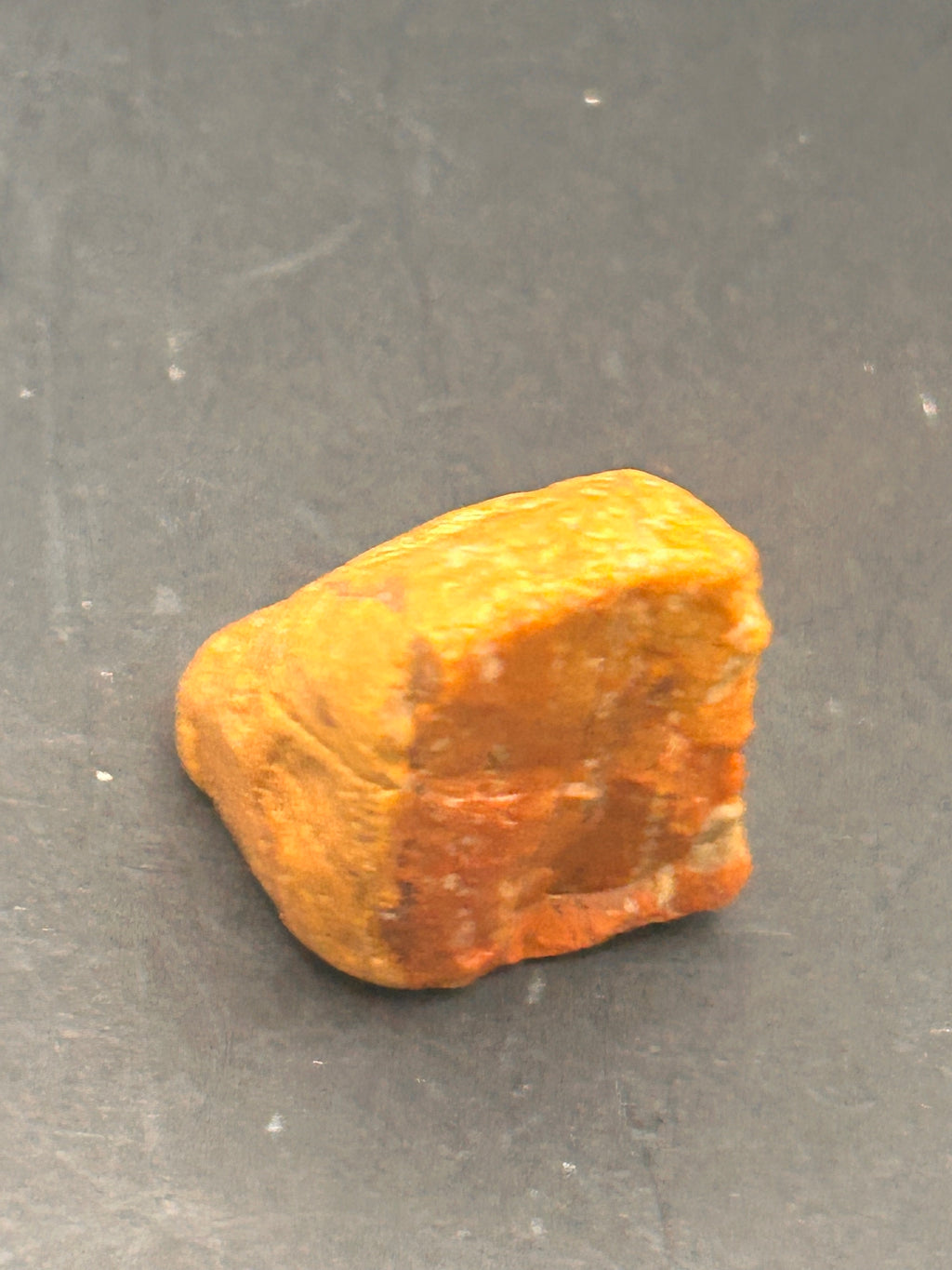 Amberroot Emberstone (1.05 oz) is a vivid fragment of petrified, jasperized wood