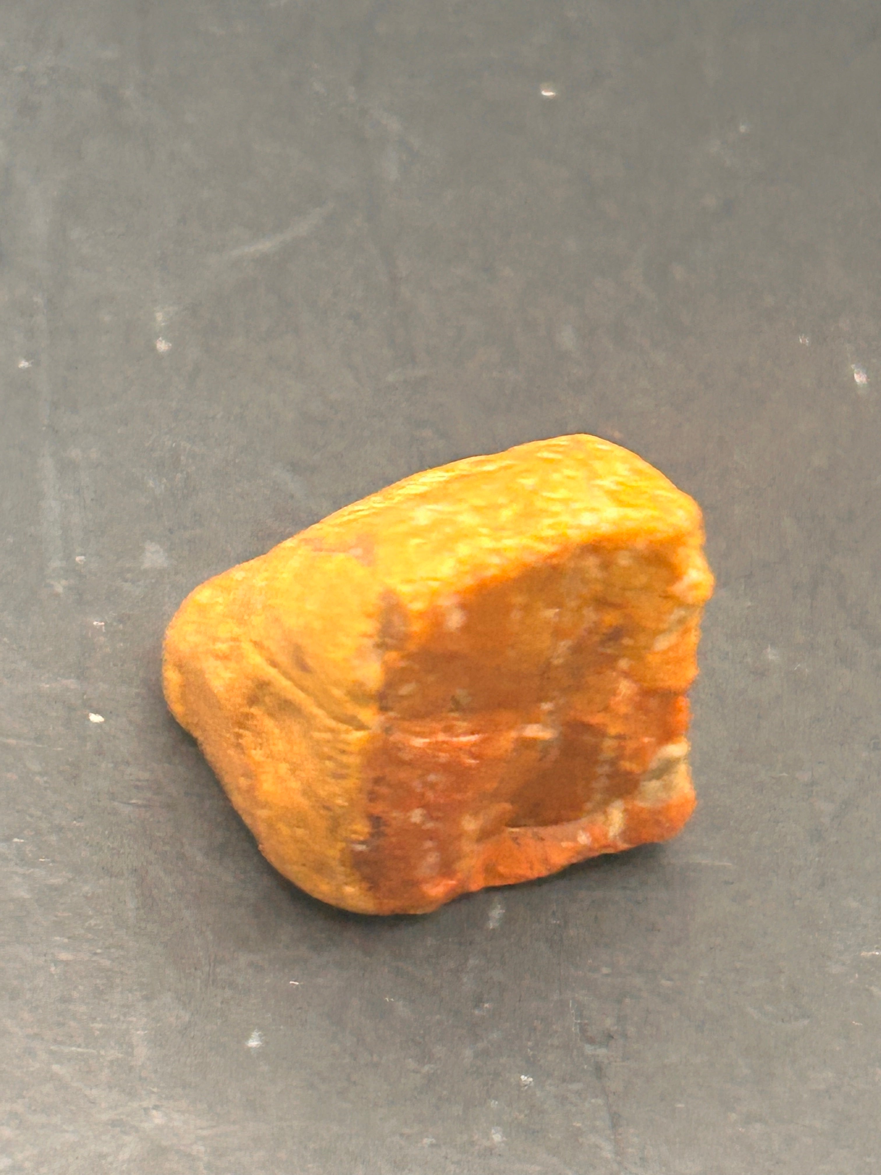 Amberroot Emberstone (1.05 oz) is a vivid fragment of petrified, jasperized wood